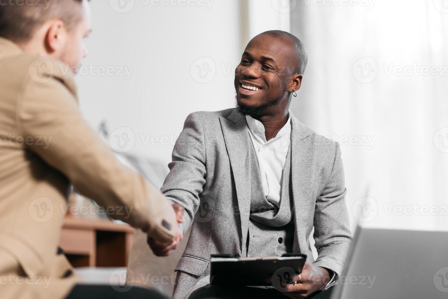 African CEO male, business men in meeting with laptop, coaching or learning in creative startup. Team, leader and discussion for brainstorming ideas, project update for event planning. Handshake, deal photo