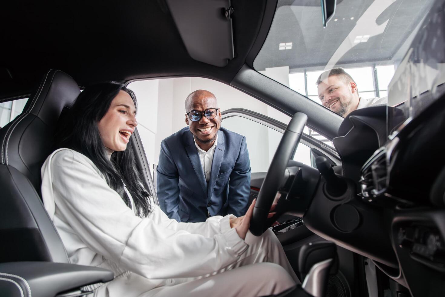 Dynamic interaction showcasing a car dealership effective communication and sales skills in promoting vehicle features to potential clients in a bright and inviting showroom photo