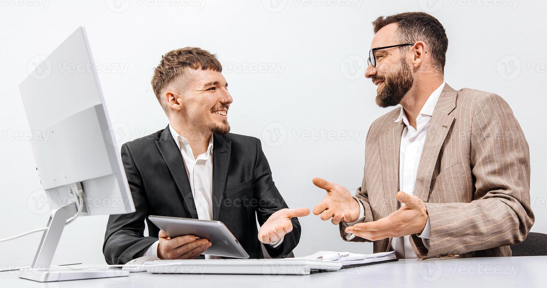 Two happy business men in the office rejoicing and showing enthusiasm for the work they have done. Successful online business and startup. The concept of winning and profits. Financial reward photo
