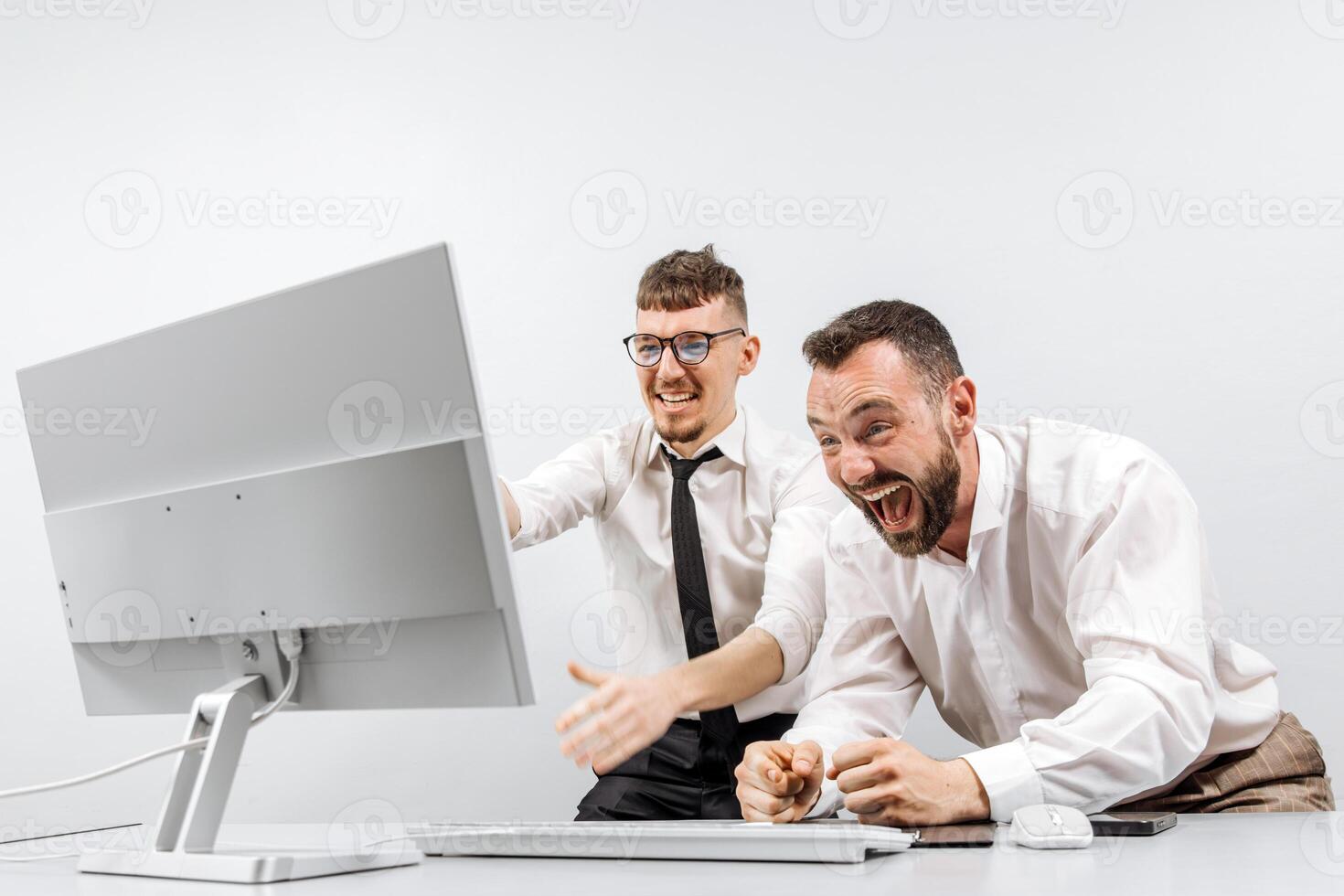 Two business men in the office rejoicing and showing enthusiasm for the work they have done. Successful online business and startup. The concept of winning and profits. Financial reward photo
