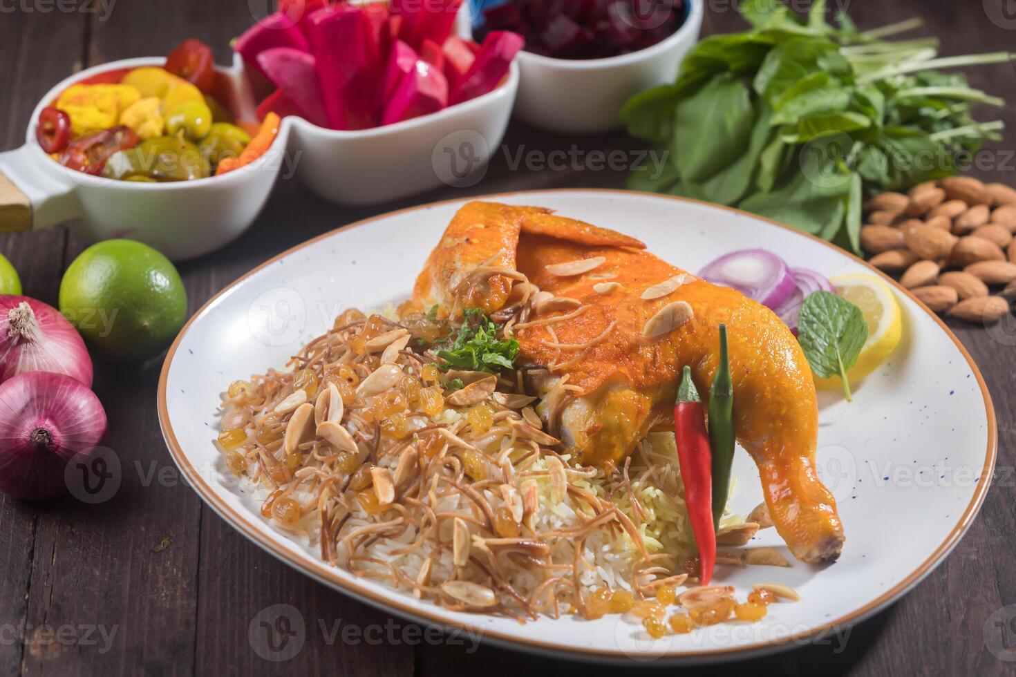 Chicken Kabsa Biryani rice garnished with nuts served in plate isolated on wooden table side view of aromatic Arabian cuisine photo
