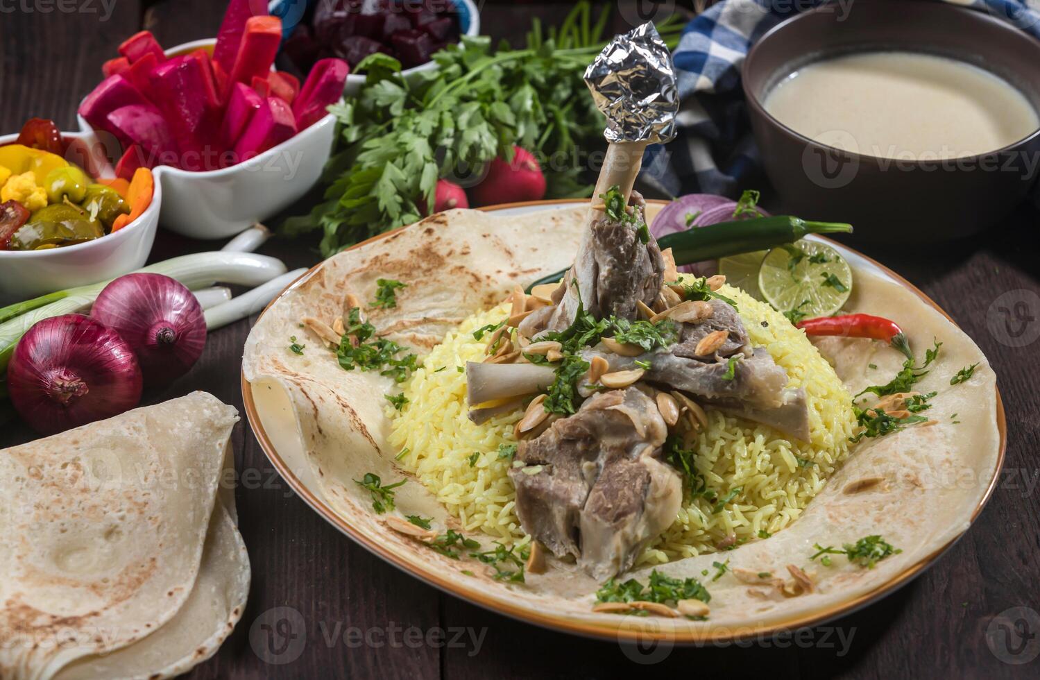 Jordanian Mansaf Arabic Meat rice served on pita bread isolated on wooden table side view of gourmet Arabic dish photo