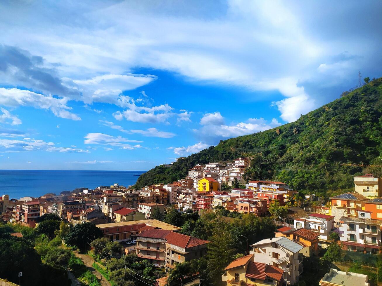 Giardini Naxos, Colorful Houses, Lush Vegetation and Crystal Clear Sea in a Mediterranean Vacation Scene photo
