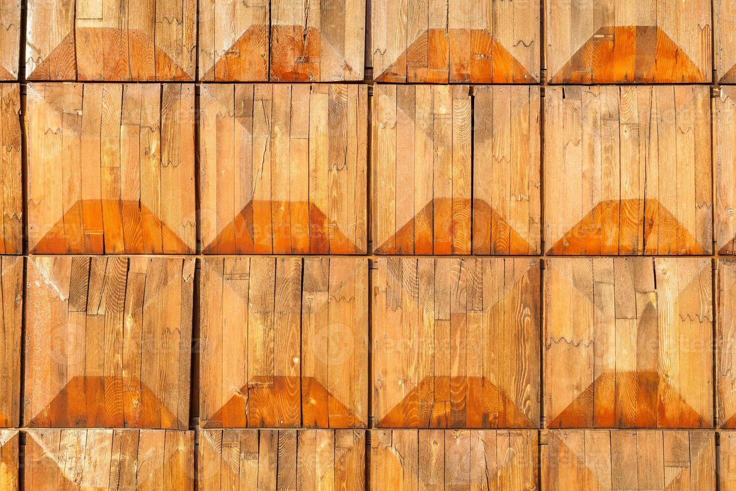 Old orange wooden square tiles texture, decoration of building wall photo