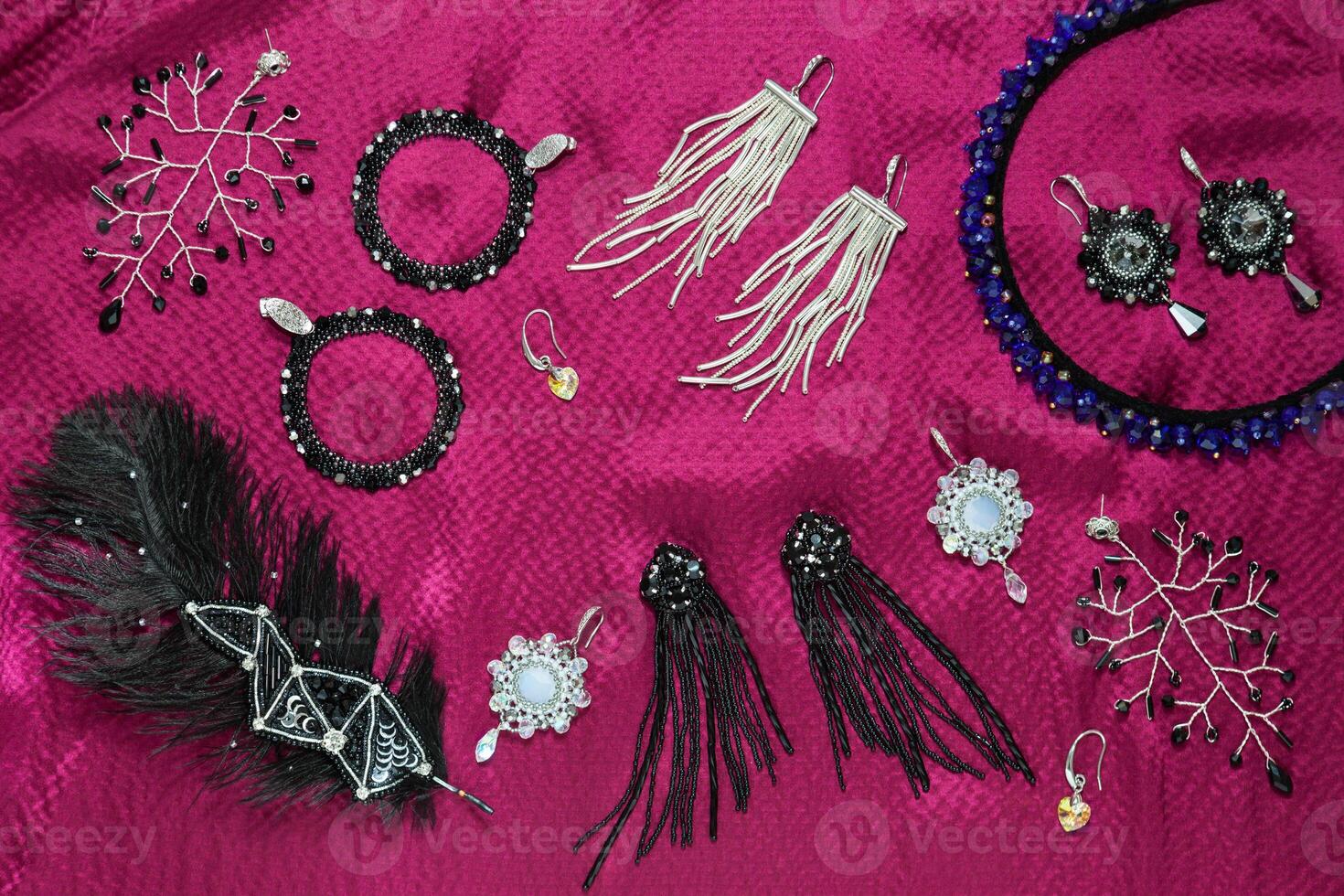 Handmade bijouterie on the pink silk background photo