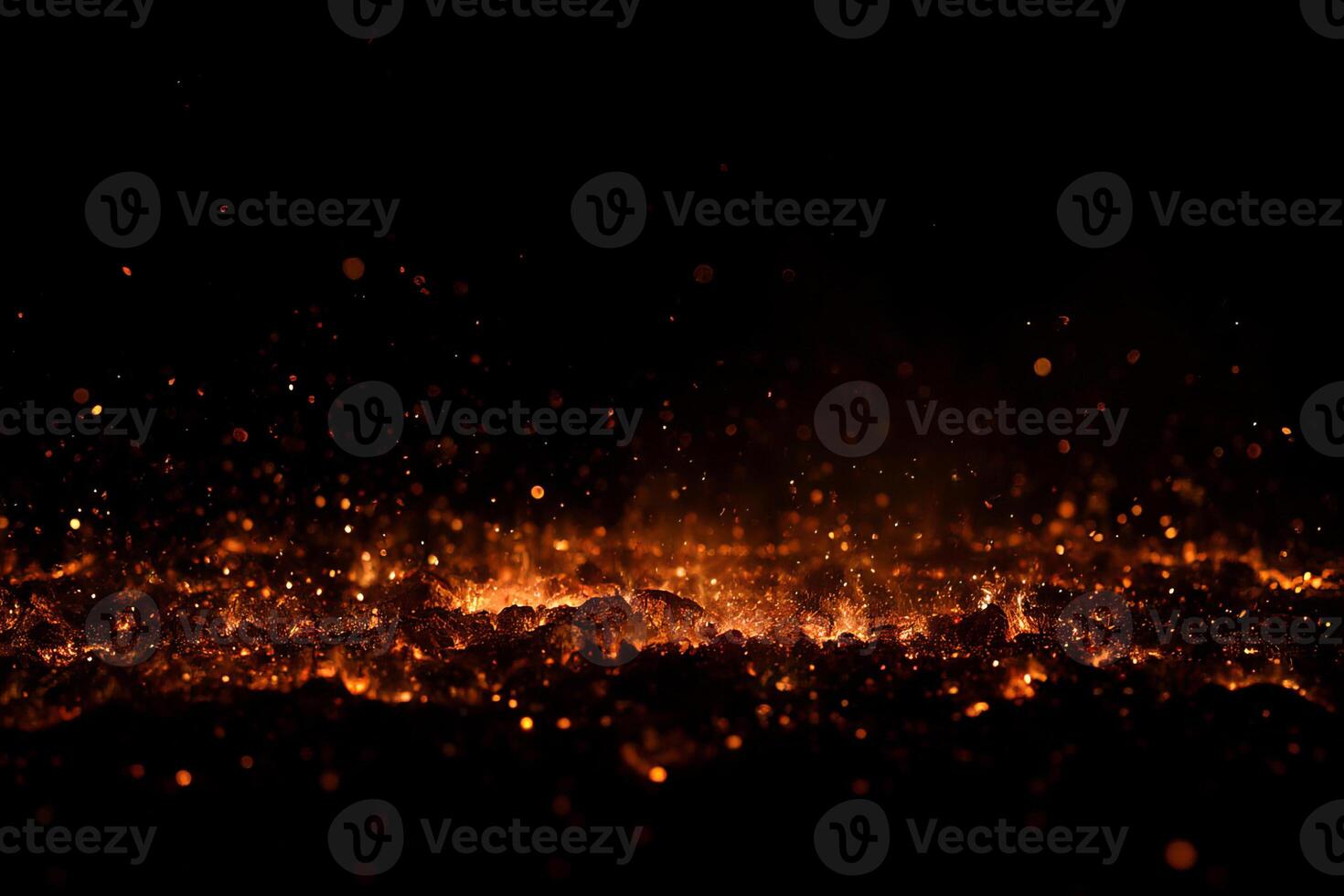 A pile of burning coal with embers and smoke against a black background, creating a dramatic and intense visual effect photo
