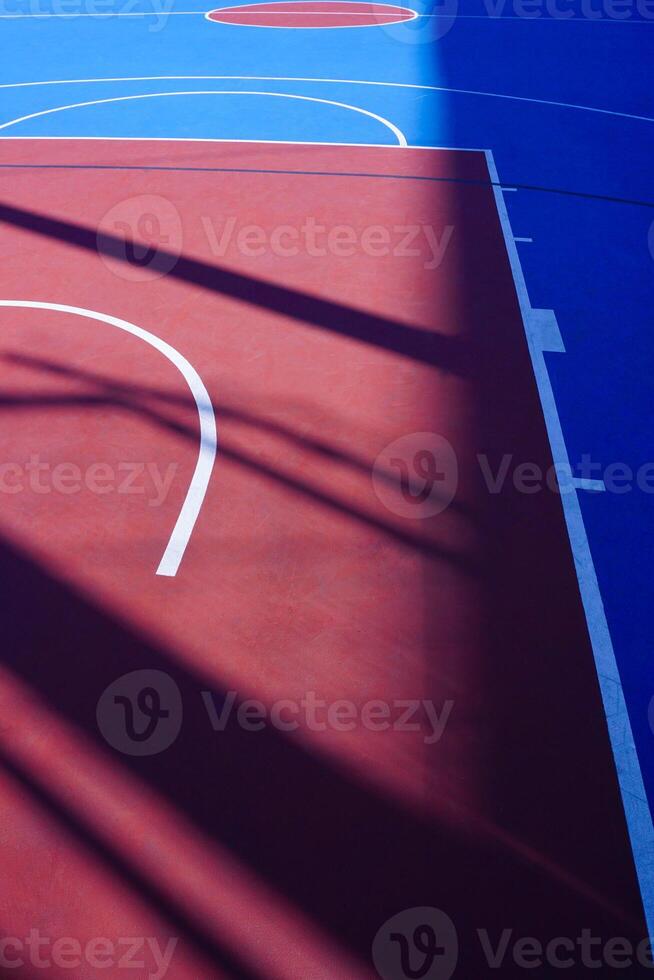 blue and red street basketball court on the street in the city photo
