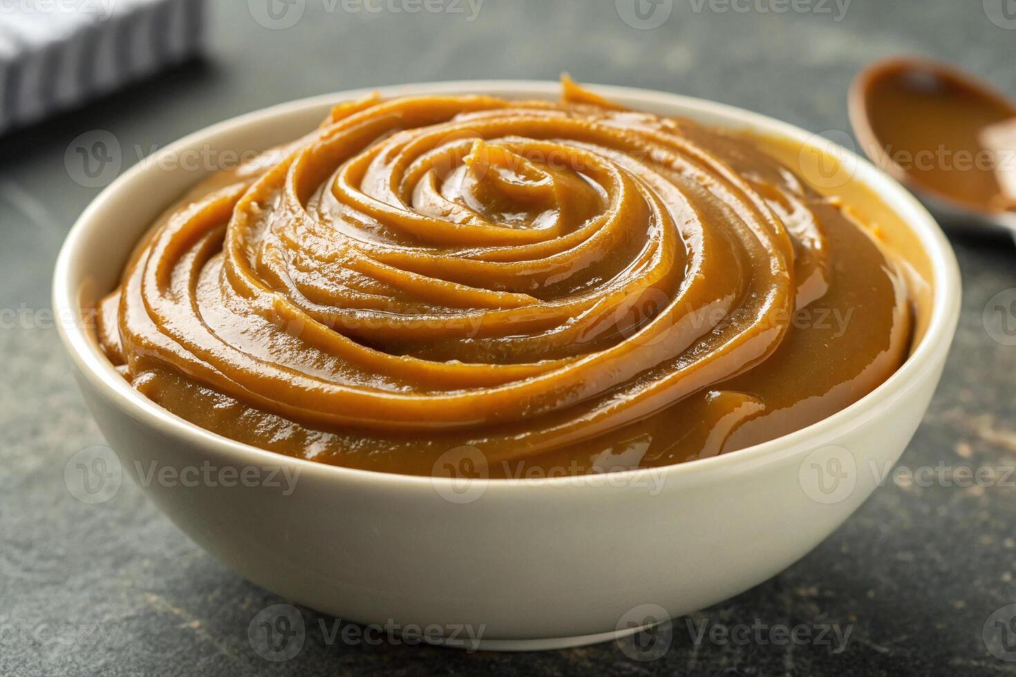 Close-up of a bowl of dulce de leche forming waves on top, HDR image, generated by ai photo