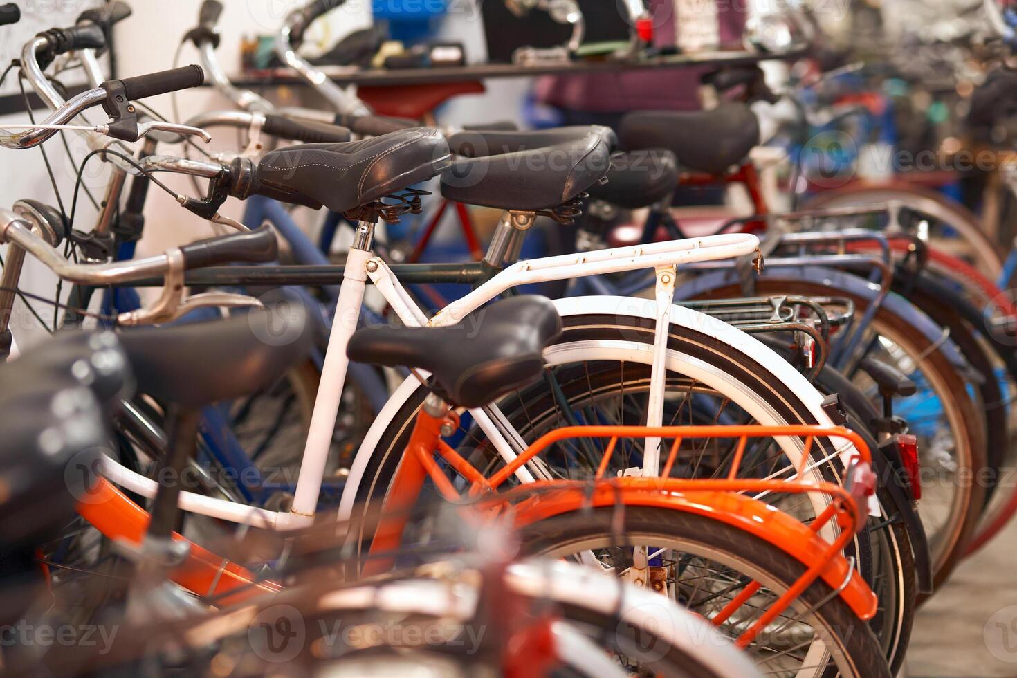 Many different bikes standing in workshop is ready for sale photo