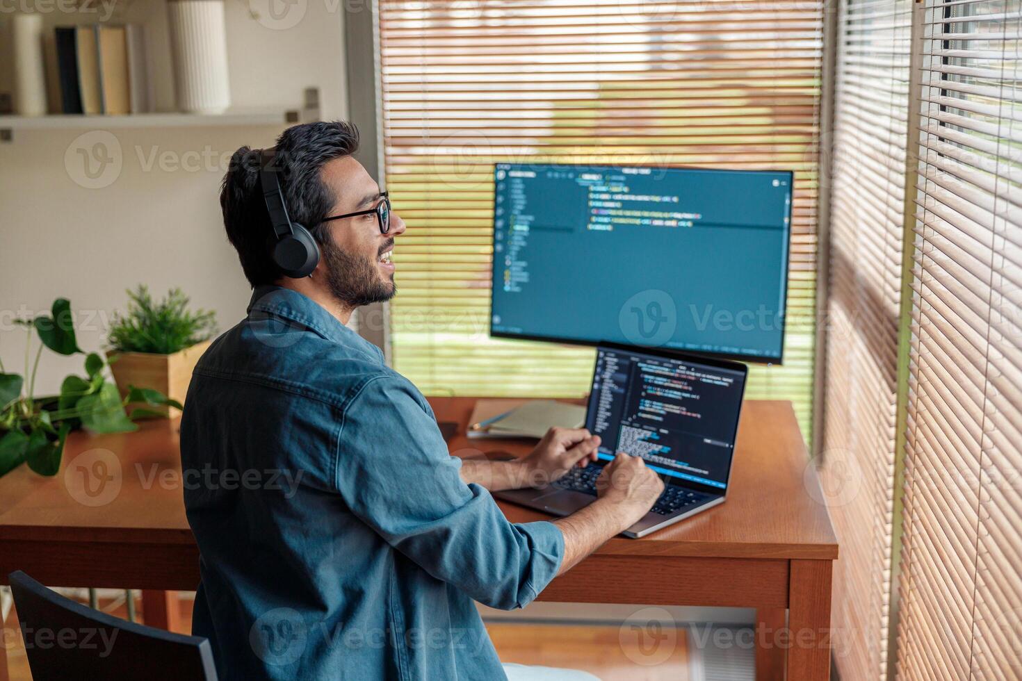 Male freelancer making new project as web designer or programmer on his computer at home office photo