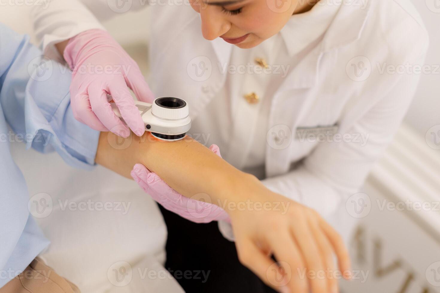 A woman getting her arm checked by a doctor photo