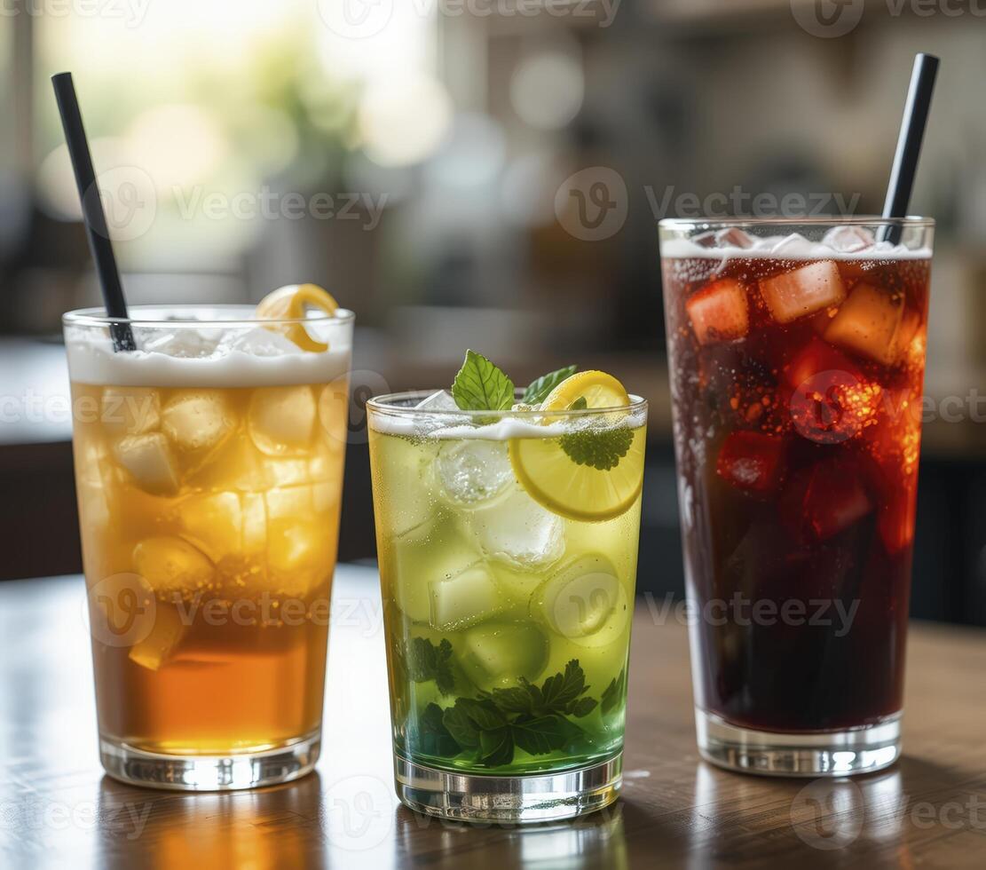 Three Iced Drinks Cola, Mint Lemonade, and Iced Tea on Wooden Table photo