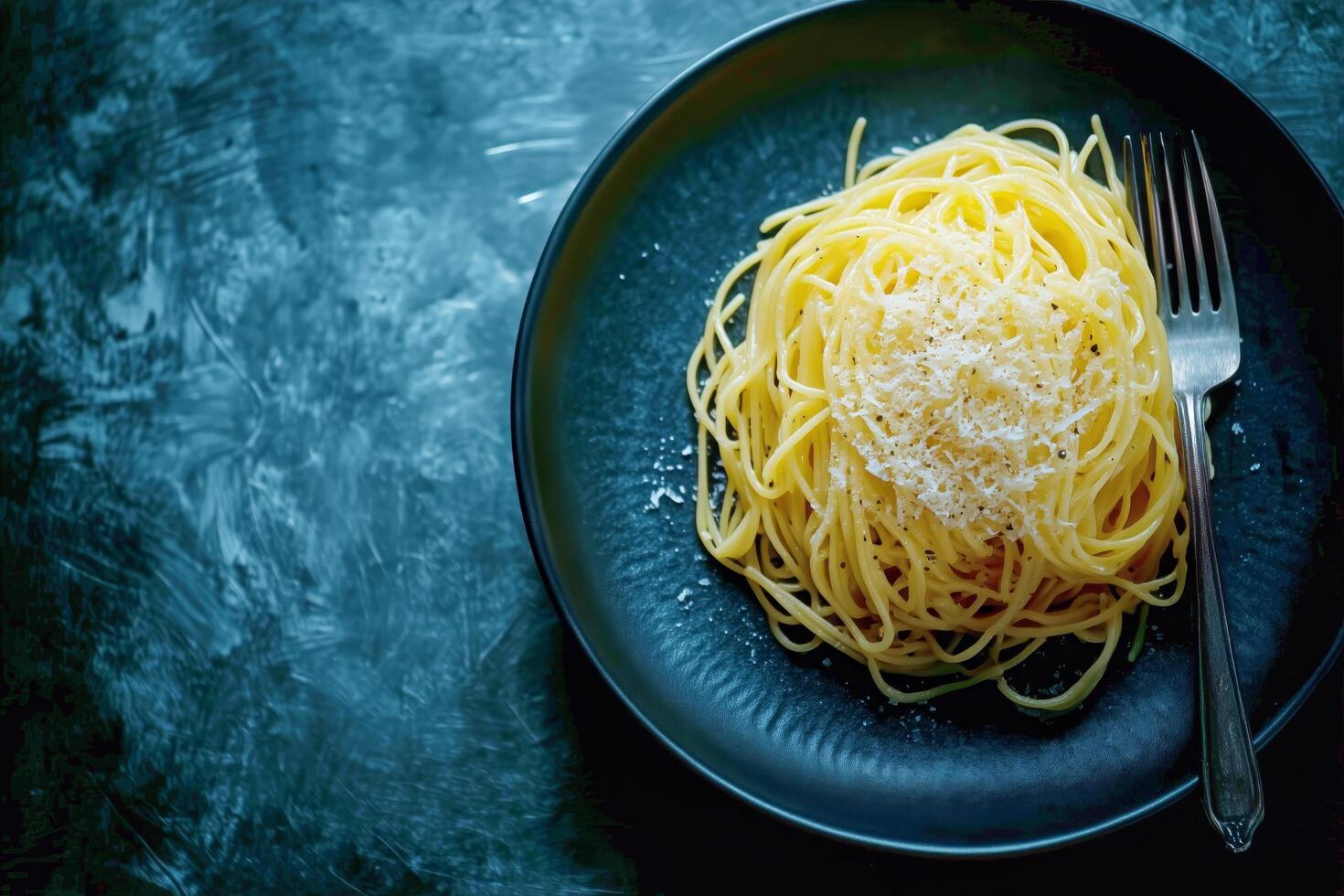 Delicious Spaghetti Topped With Cheese Served on a Dark Plate for a Simple yet Elegant Meal photo