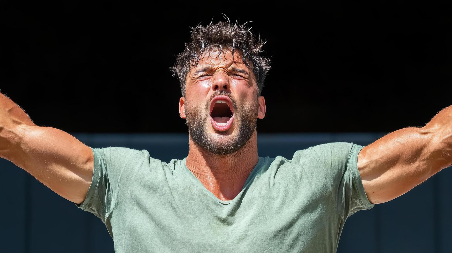 A man with his arms raised up and shouting photo