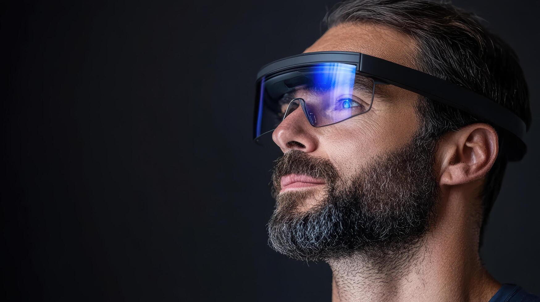 A man wearing a pair of glasses with blue light photo