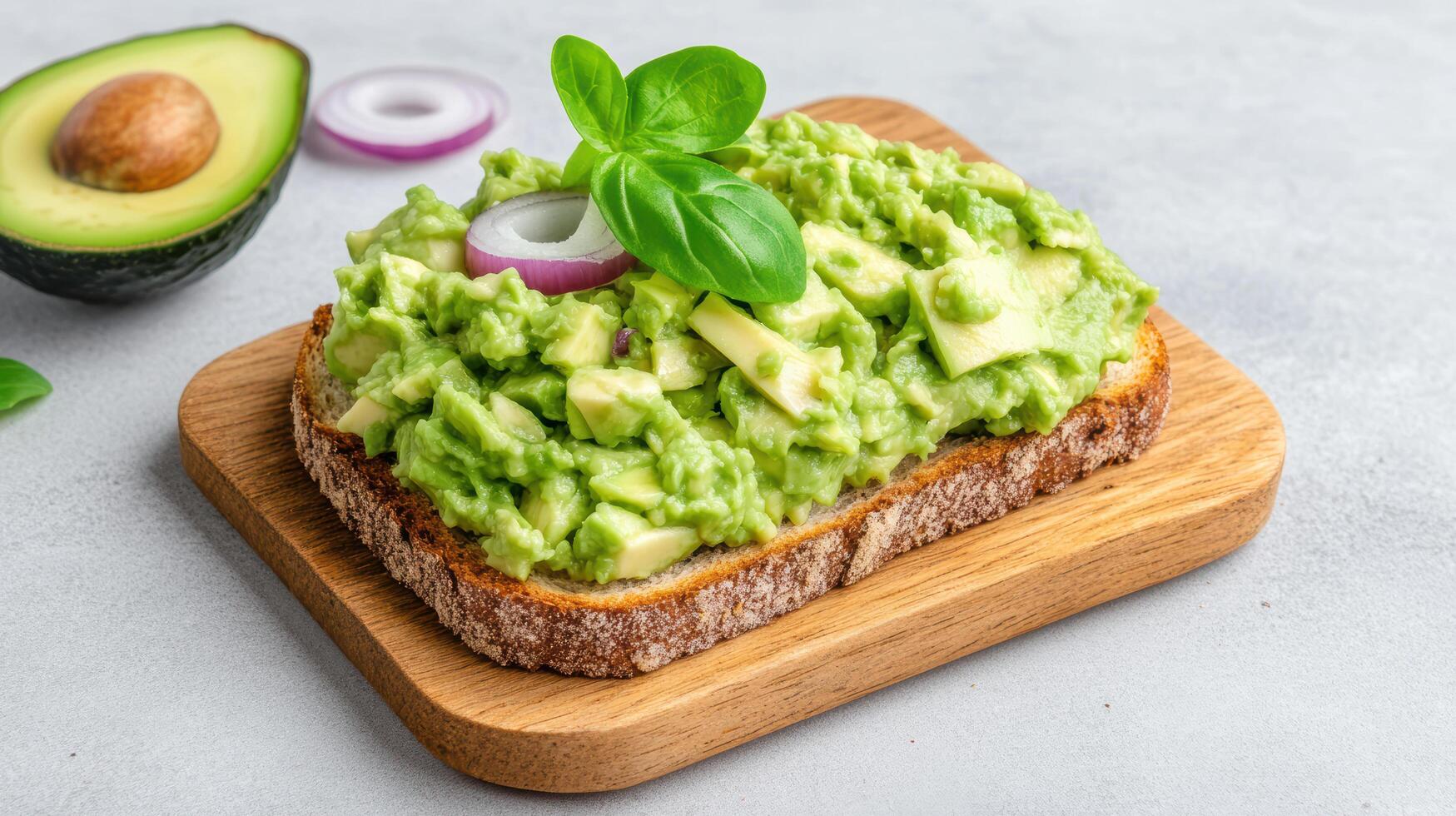 Avocado toast with avocado, onion and basil on a wooden board photo