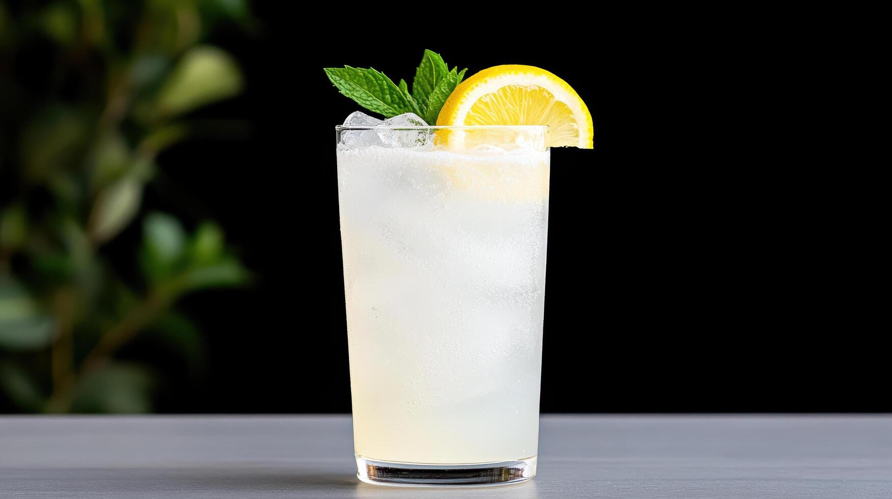 A lemonade drink with a slice of lemon and mint photo