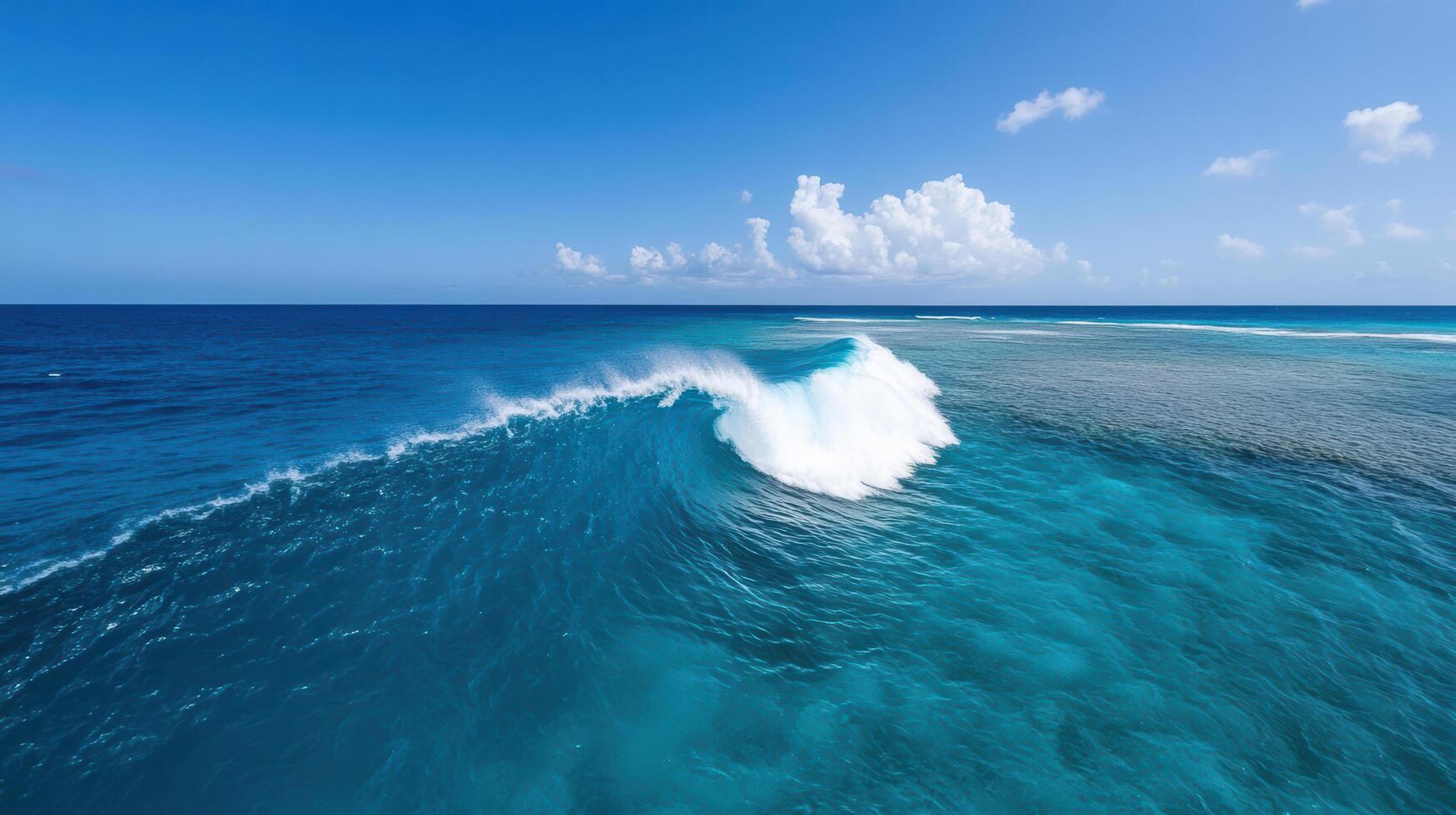 A large wave in the ocean with a blue sky photo