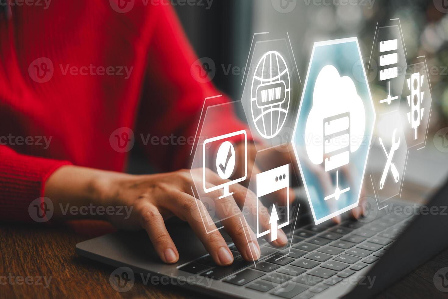 Hands typing on a laptop with digital icons representing web hosting, cloud computing, and server technology. photo