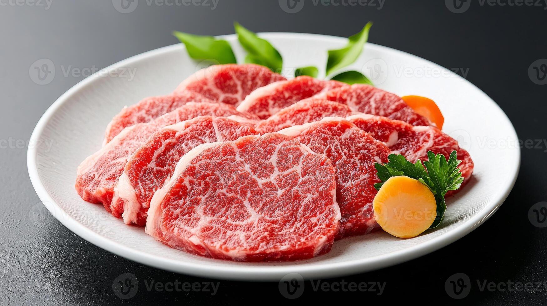 A plate of raw beef with a slice of lemon photo