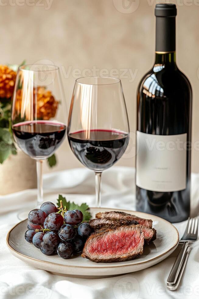 A plate with a steak and grapes on it photo