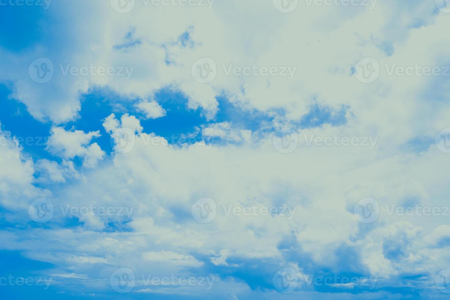 Serene blue sky with billowing clouds, a vista of boundless expanse and freedom photo