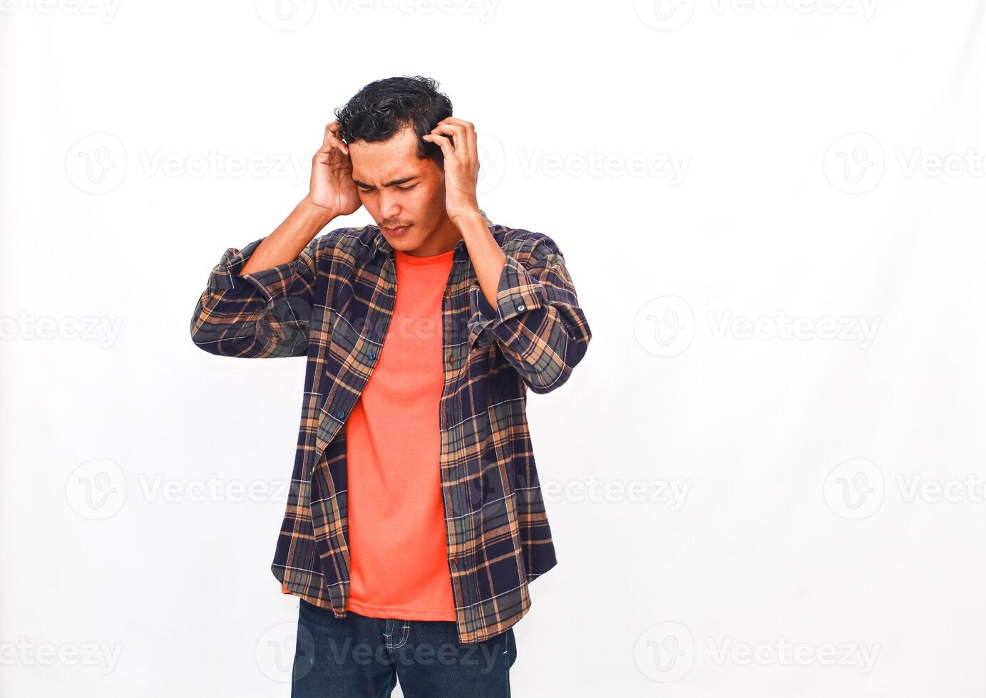 Stressed young man with hands on head showing desperation and frustration isolated photo