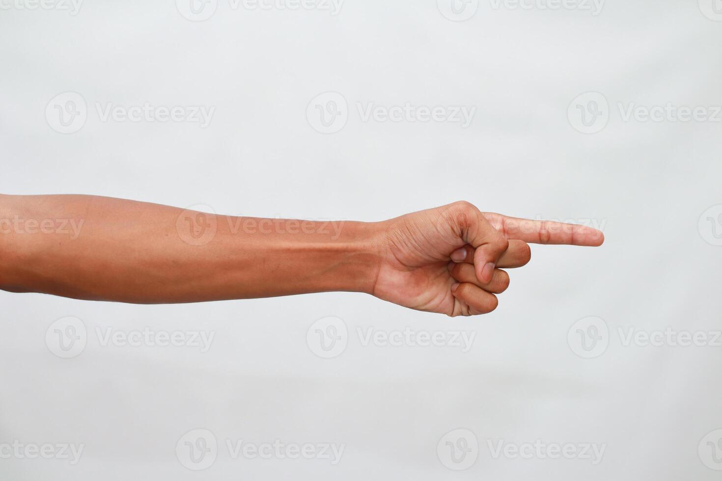 Brown Skin Hand Pointing Right Against Light Background Studio Shot photo