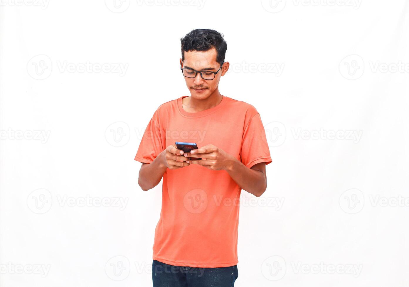 Young adult engrossed in smartphone activity on isolated plain background photo