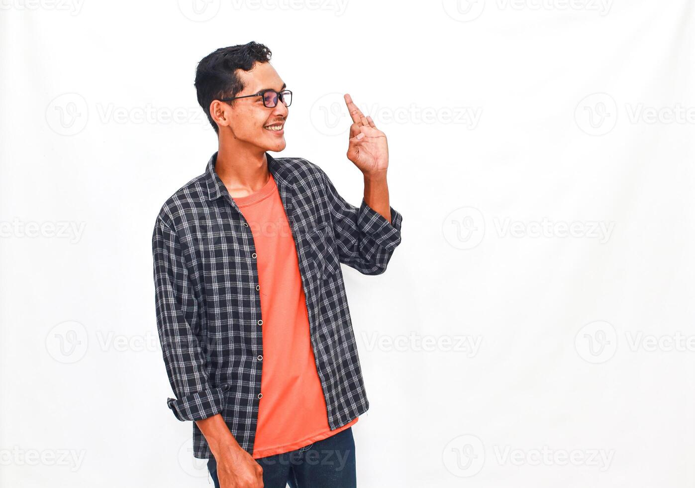 Smiling Young Man In Plaid Shirt Gesturing Idea On White Background photo