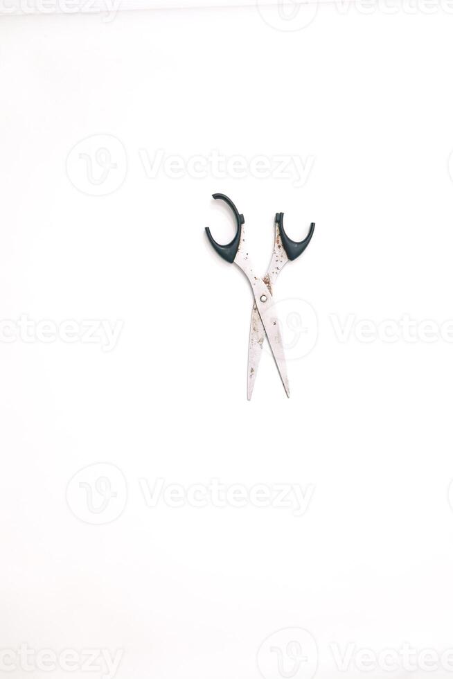 Simple Still Life Depicting Open Scissors with Rust on a White Backdrop photo