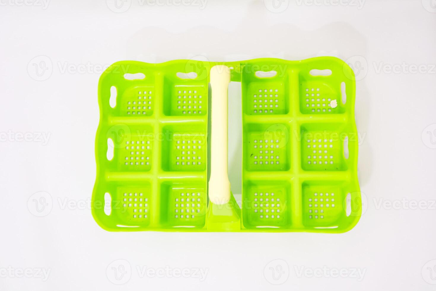 Creative Bright Green Ice Cube Tray on Clean White Backdrop for Refreshing Drinks photo