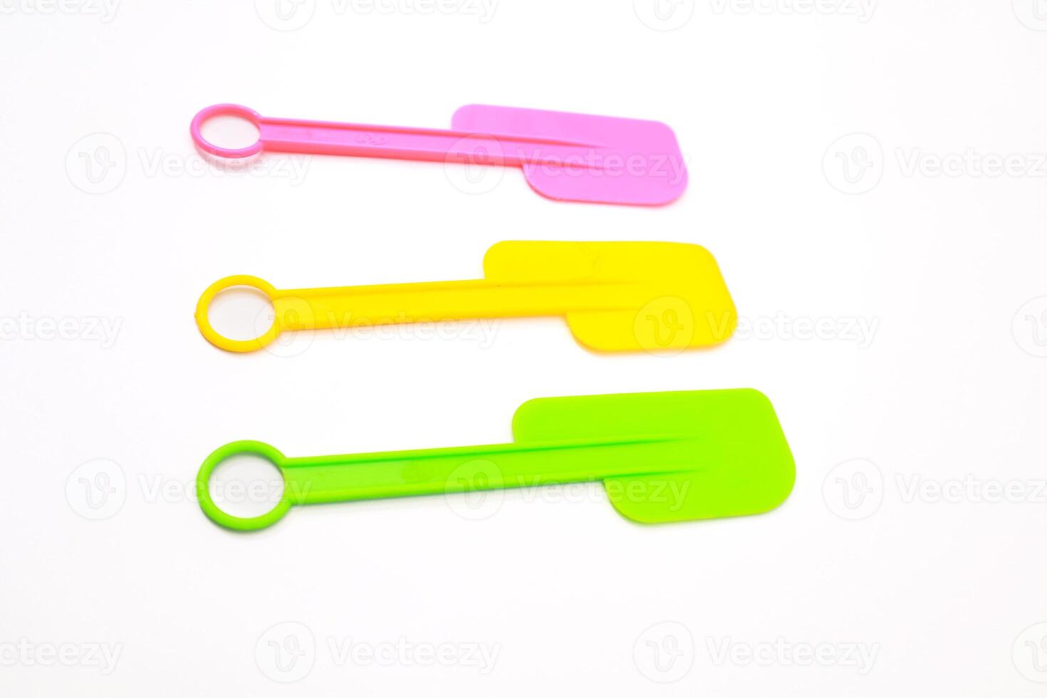 Colorful Silicone Spatulas Arrayed on a White Surface for Culinary Use photo