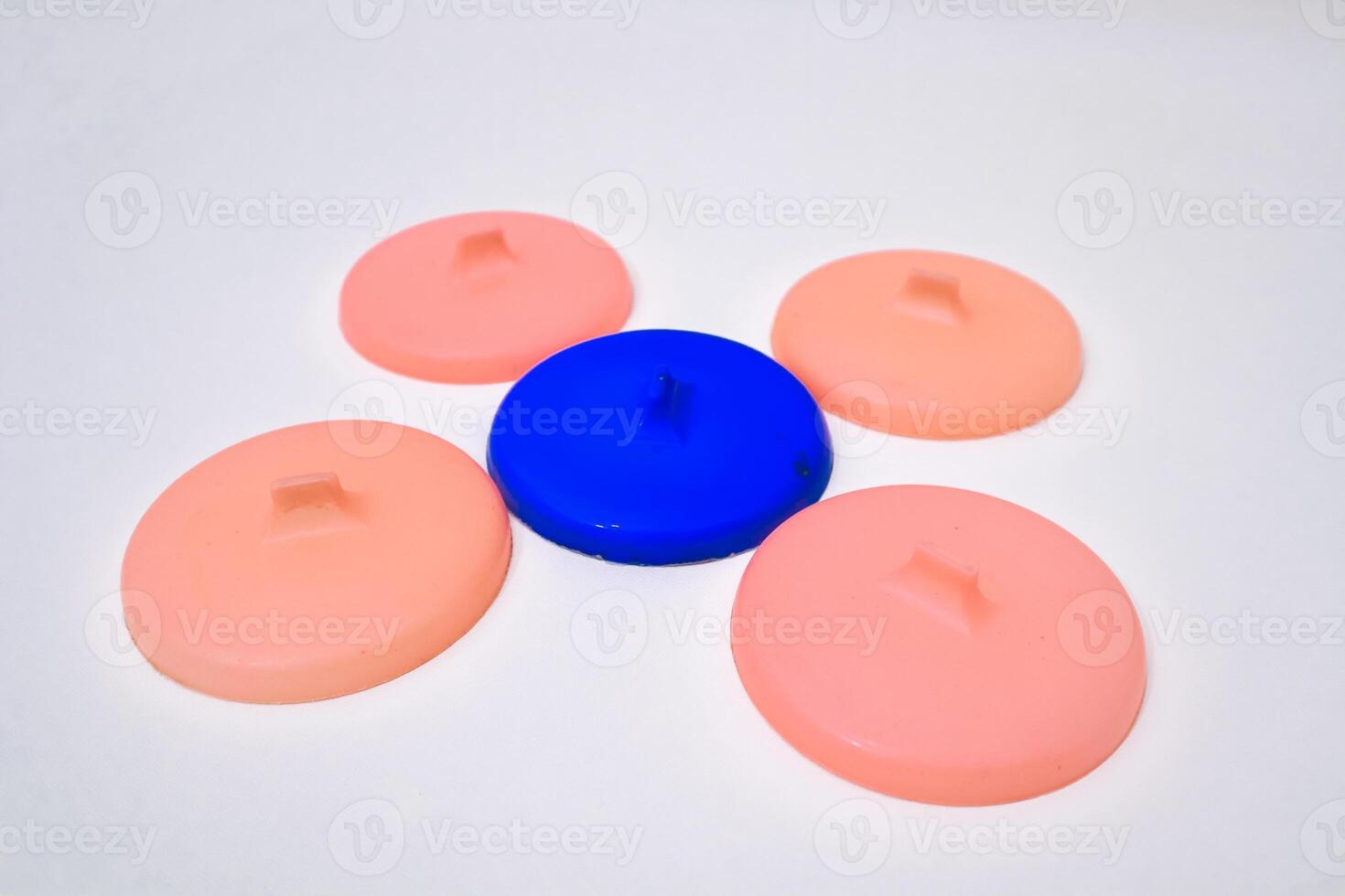 Abstract composition of colorful plastic lids arranged on white background photo