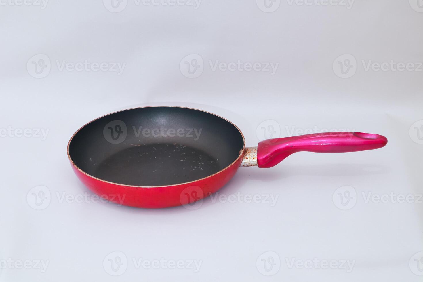 Red frying pan with non-stick surface, a staple cooking tool in modern kitchens photo