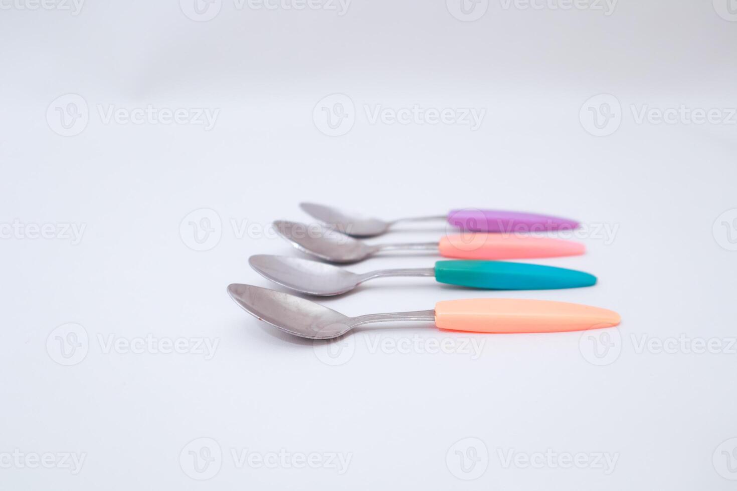 Pastel Handle Spoons Arrayed on Clean White Background, Kitchen Flatware photo