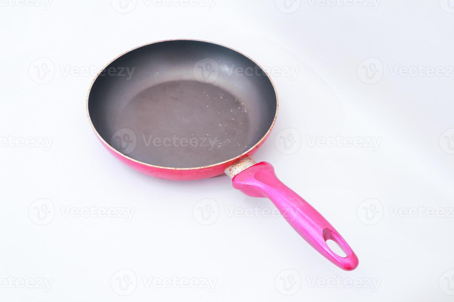 Isolated pink frying pan on a white surface providing a clean aesthetic photo