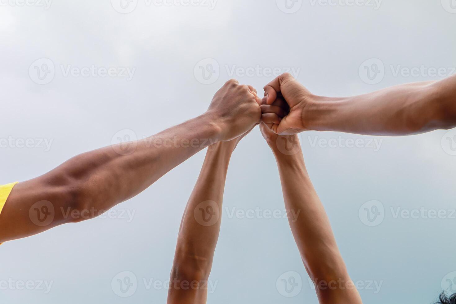Diverse Team Fists Bump in the Sky Showcasing Unity and Teamwork Spirit photo