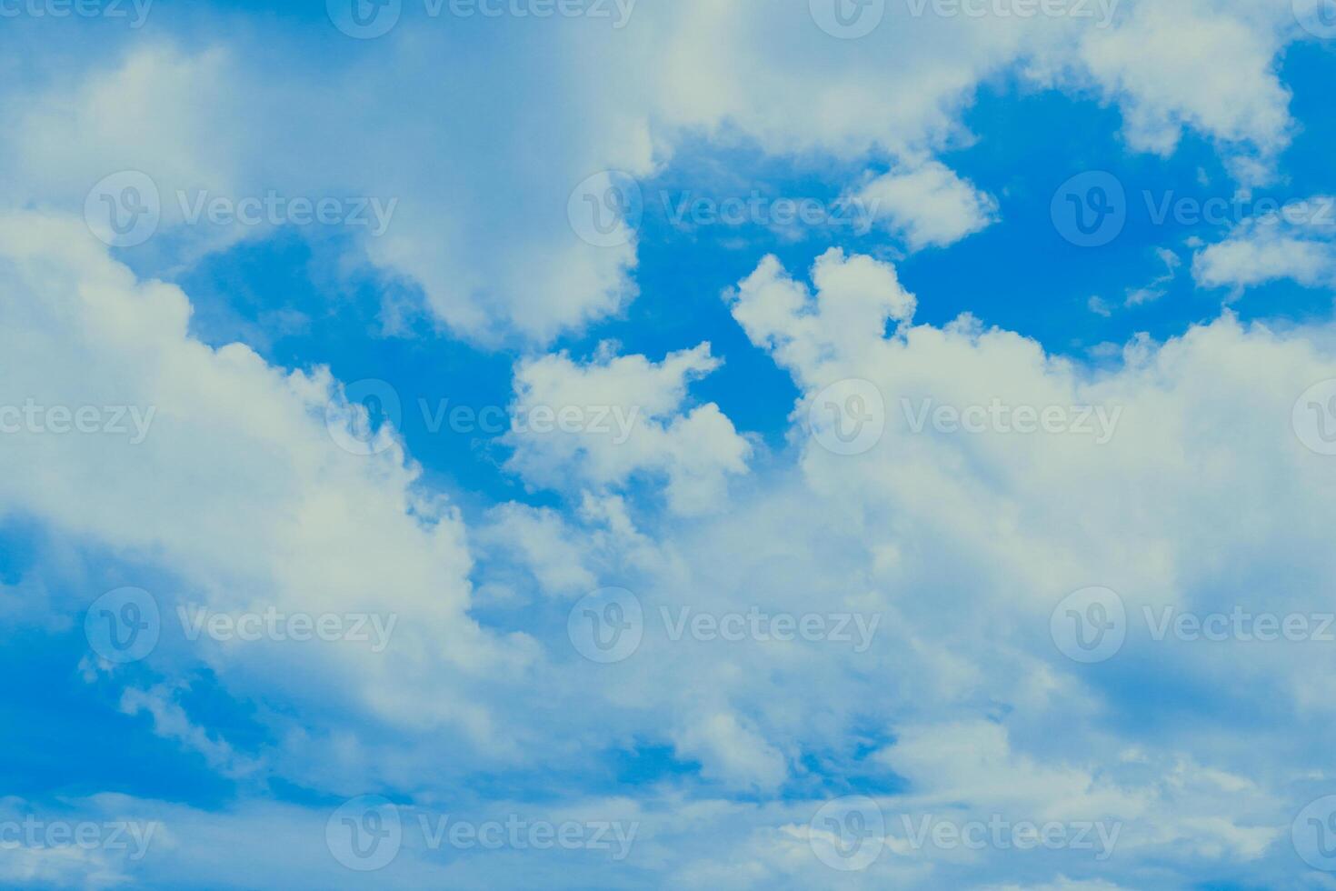 Billowing White Clouds Against an Azure Sky - Serene Atmospheric View photo