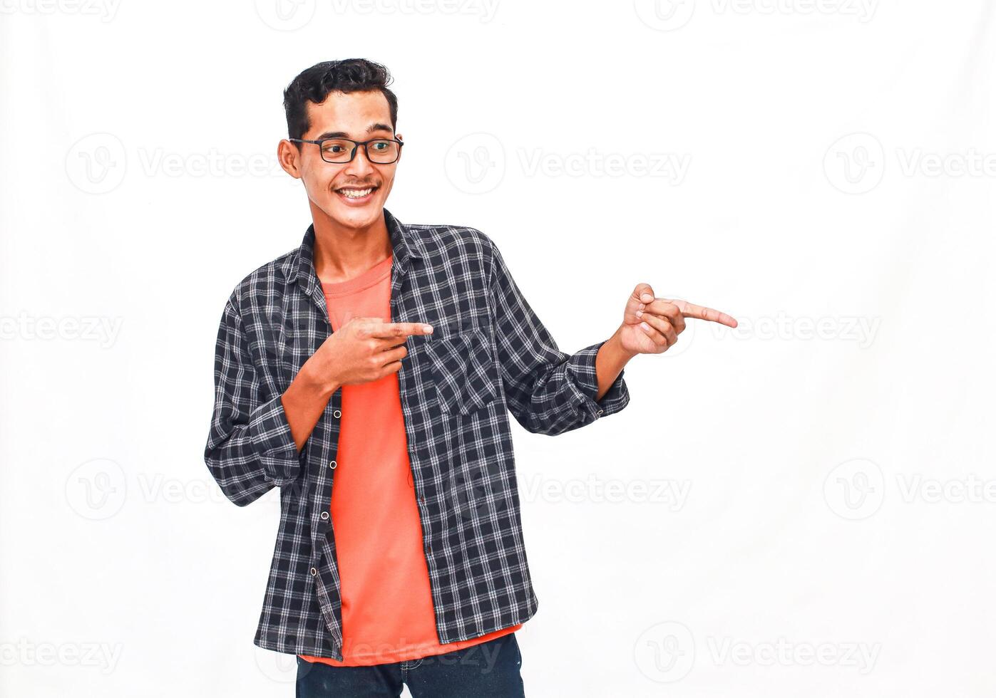 Smiling Young Man Pointing Gesturing In A Casual Shirt, White Background photo
