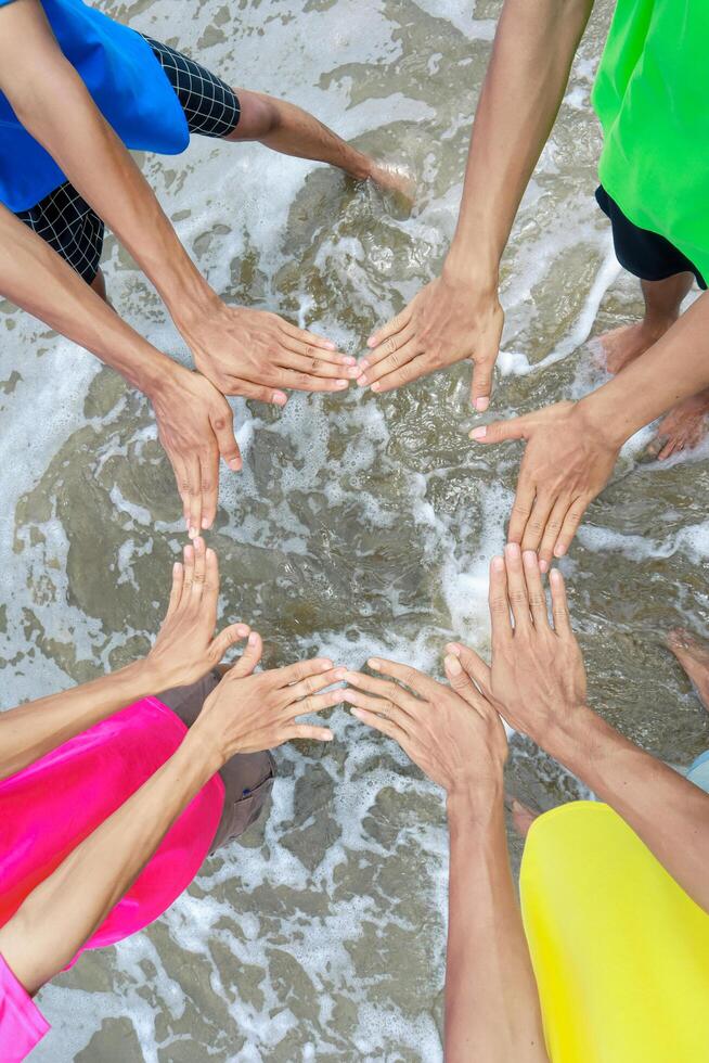 Hands United in Coastal Waters, Fostering Unity and Teamwork photo