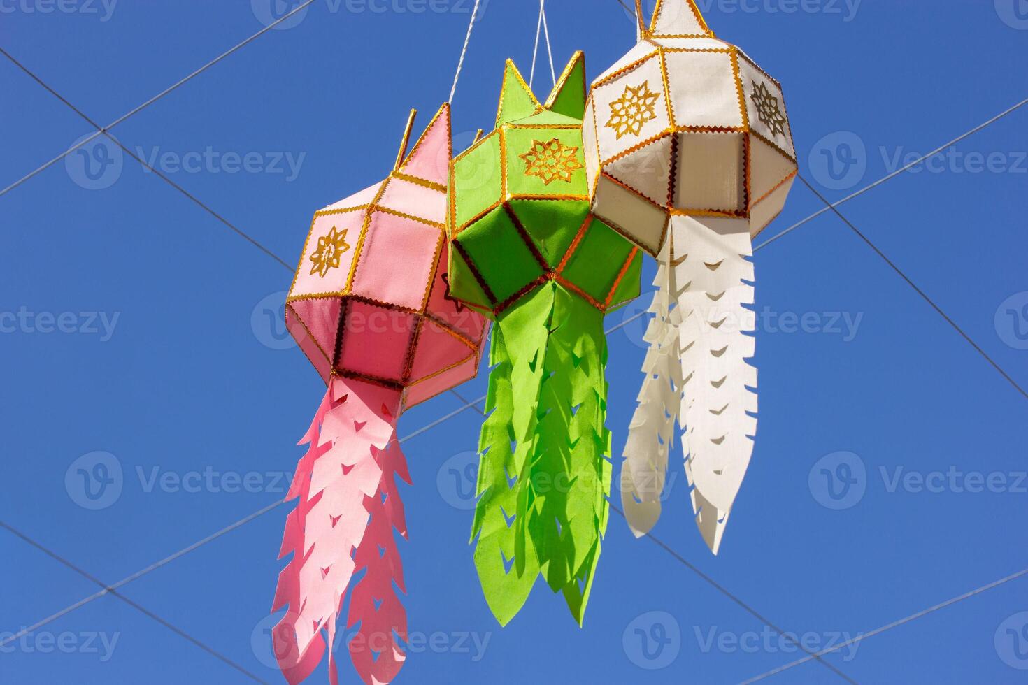 three colorful hanging lanterns lighting in loy krathong and new year festival at northern of thailand photo