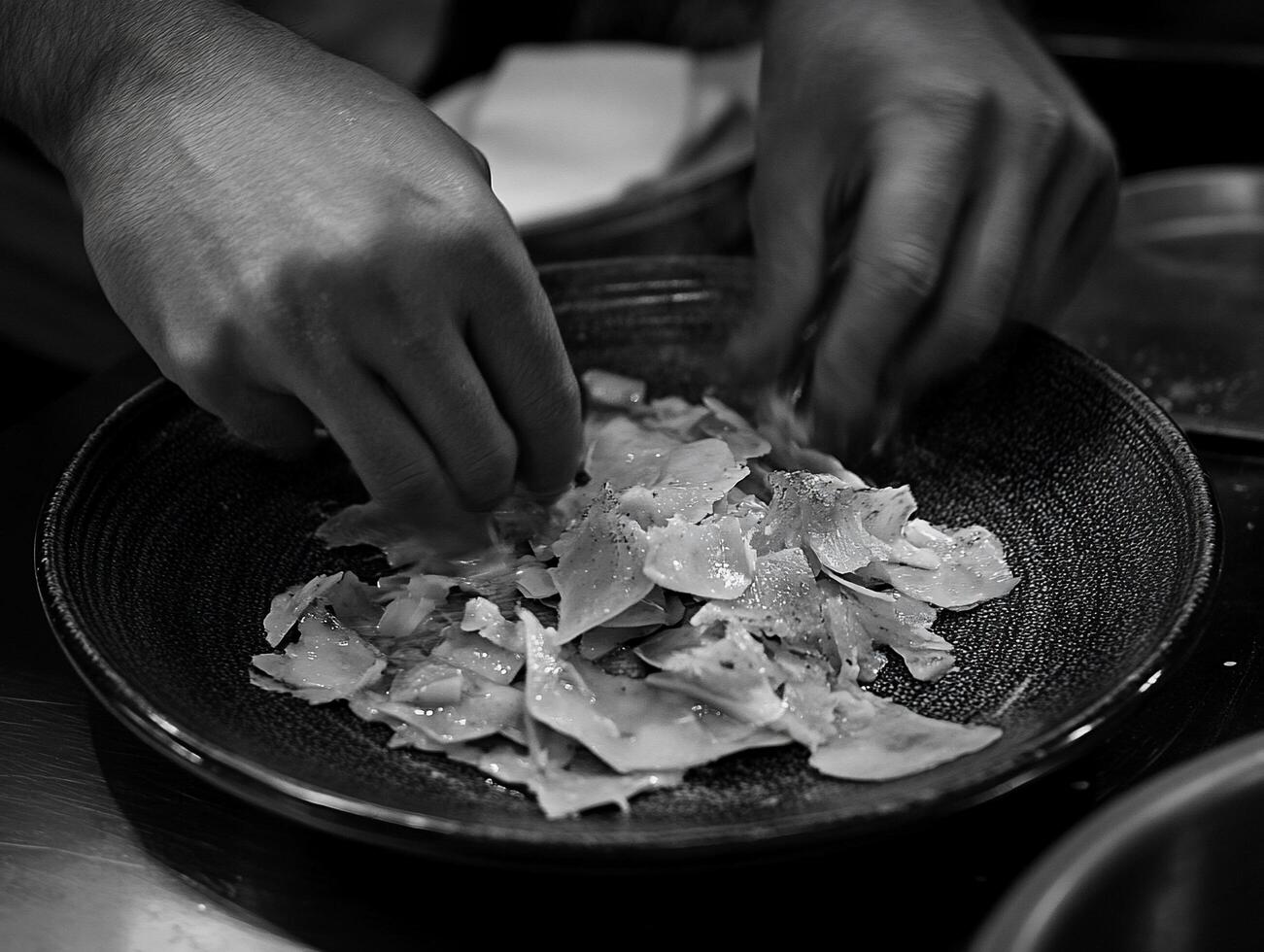 Chef plating delicate dish, kitchen setting photo