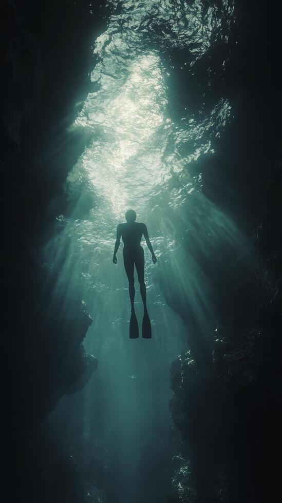 A man in a scuba suit swimming in the ocean photo