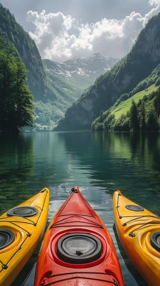Three kayaks are sitting on the water in front of a mountain photo