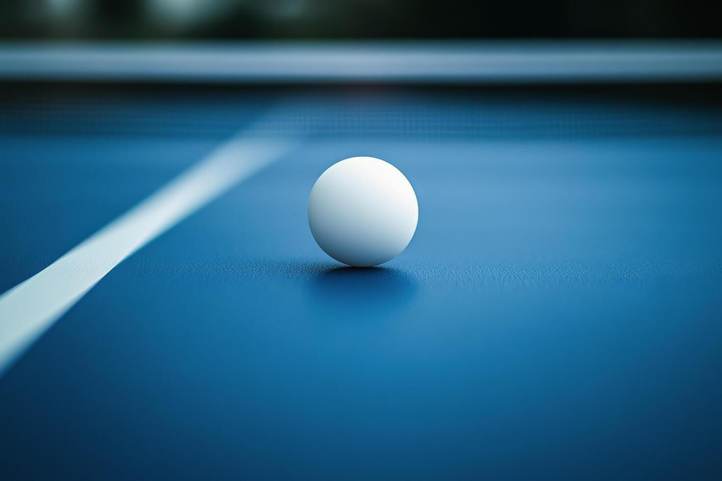 A white egg sits on a ping pong table photo