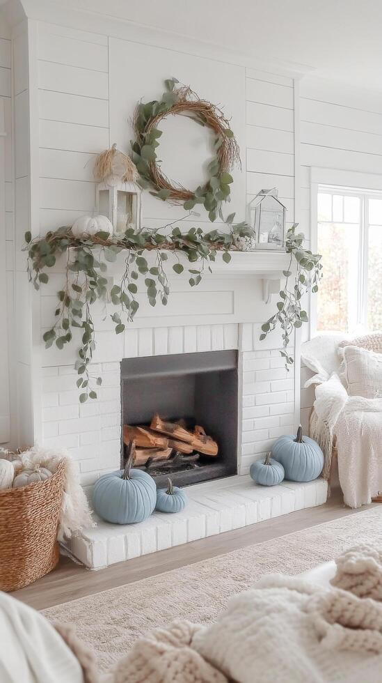 A white fireplace with a wreath on it and a basket of pumpkins photo