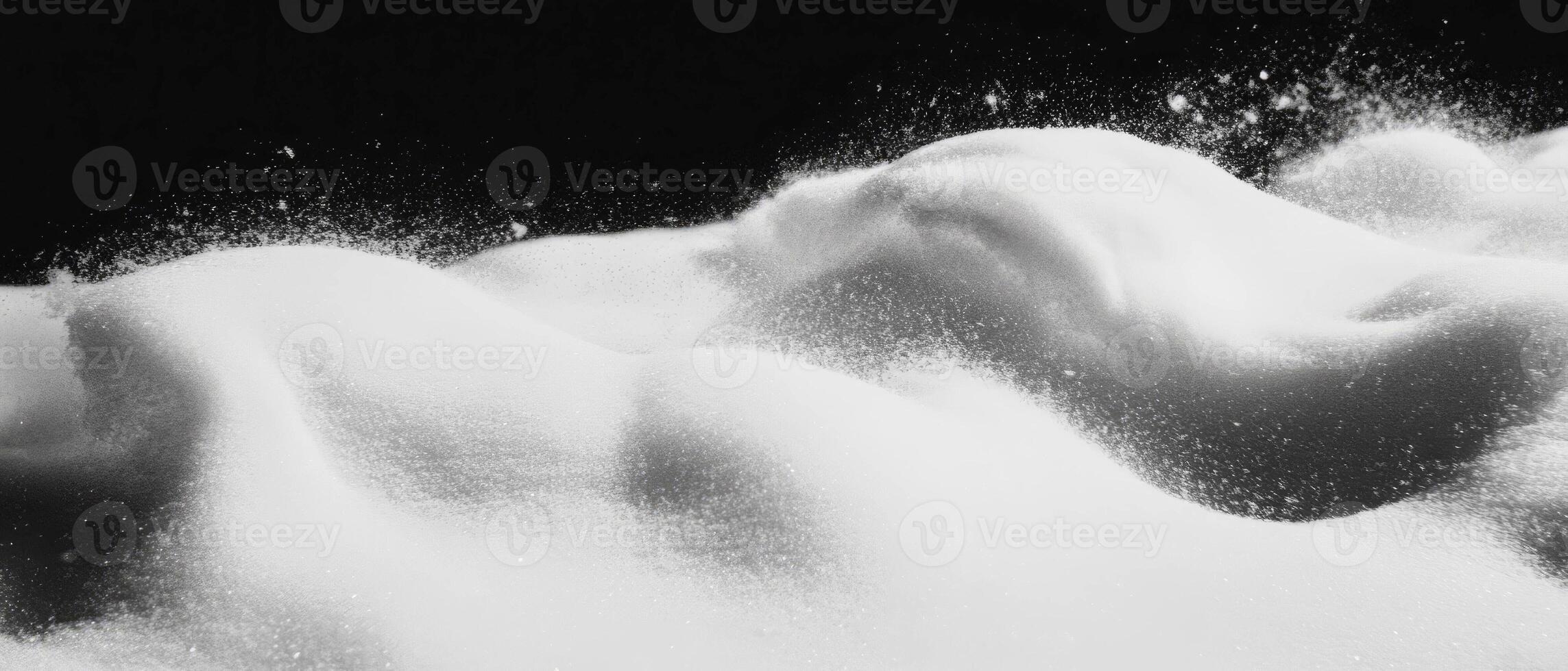 Drifting snow with swirling patterns against a black background creating a serene atmosphere photo