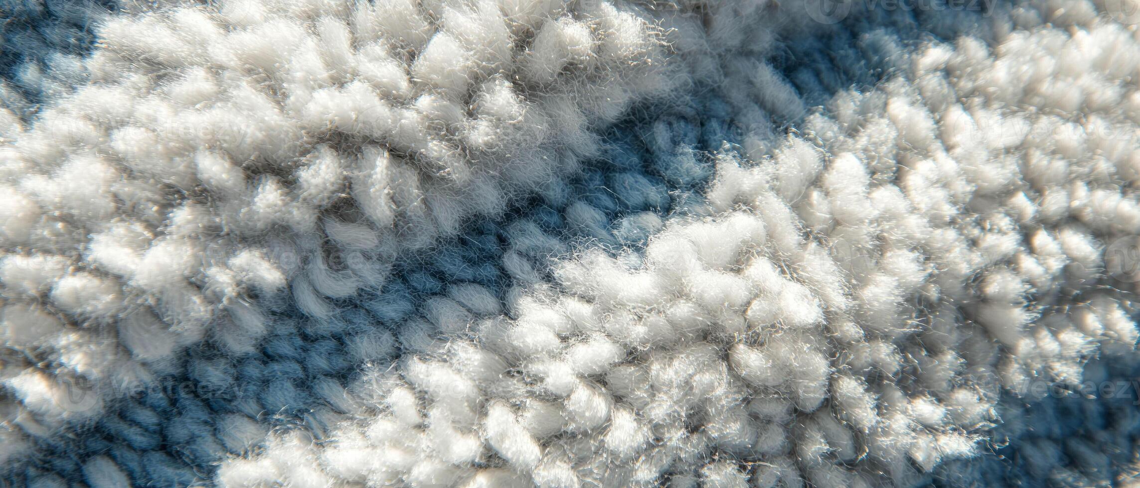 Soft and textured tufted carpet with looped pile in shades of blue and white photo