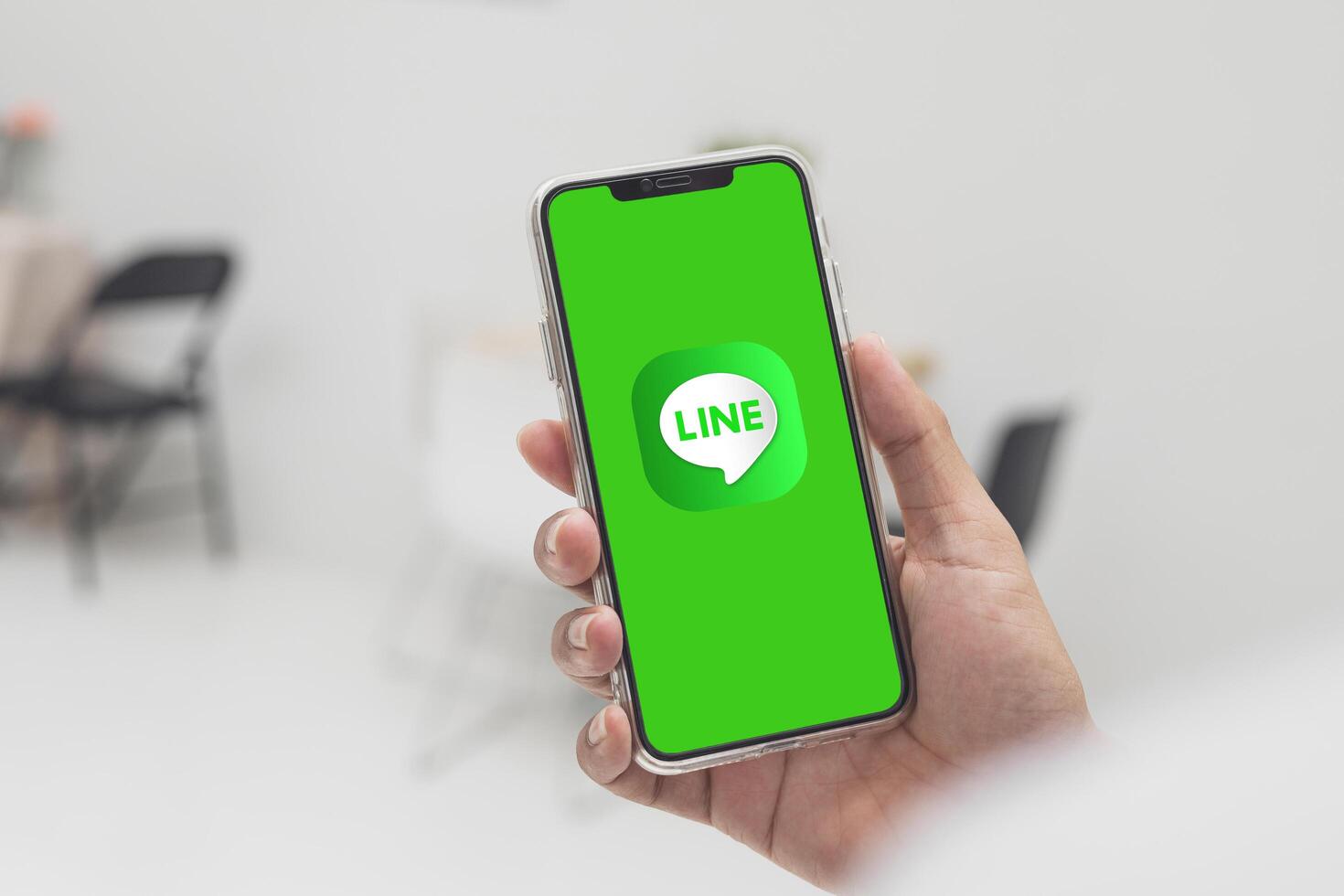 Bangkok, Thailand-13 April 2025. Popular LINE logo on smartphone, Businessman opening the LINE application on device for convenient, and fast communication and delivery of document file. photo